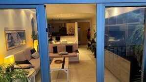 A modern living room with a sofa, coffee table, and a dining area in the background. - BEAUTIFUL VIEWS ON PLAYAS GEMELAS BEACH (PUERTO VALLARTA)