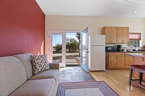 A modern kitchen with wooden cabinets, a refrigerator, and a countertop with appliances.