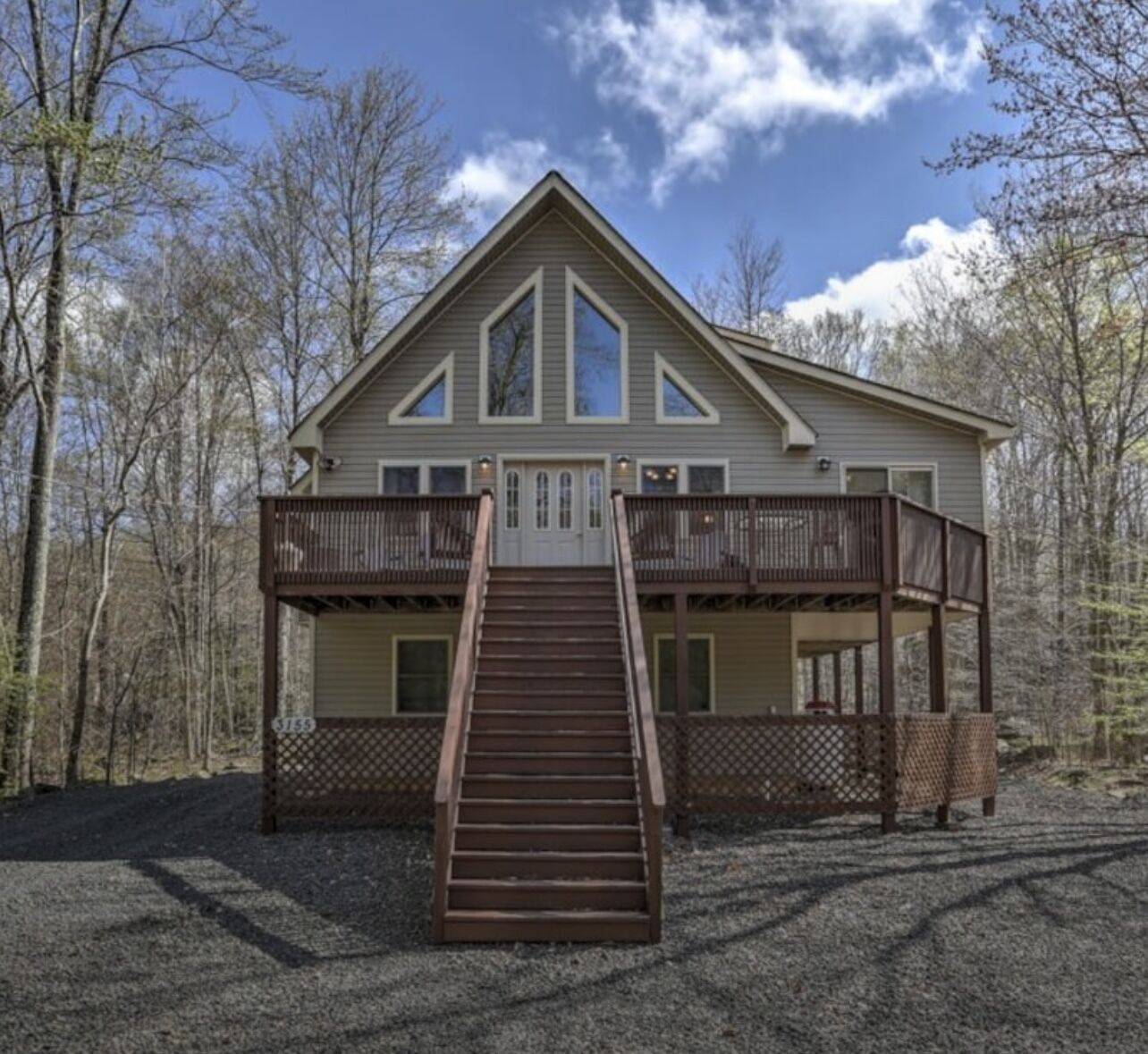 A captivating chalet-style cabin nestled in a gated community on a scenic lake.