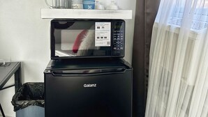 A compact kitchenette with a microwave, a coffee maker, and a small shelf with kitchenware. - 💎 Chic Private Room 🛜 Fast Wi-Fi 👣Near LIRR & Shops (Hicksville)