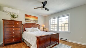 A bedroom with a wooden bed, dresser, and a ceiling fan. - Niantic Duplex w/ Deck < 1 Mi to Beach + Boardwalk (Niantic)