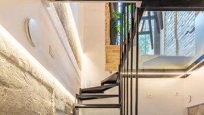 A modern staircase with a glass enclosure leading to a hot tub area. - Cuddle Puddle  (Vilnius)