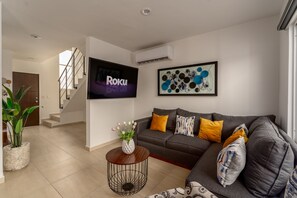 Standard House | Living area | 80-inch Smart TV with digital channels, Netflix, streaming services