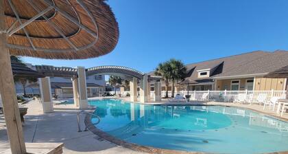 Spacious condo sleeps 6, has 2 pools, a playground and is close to the beach.