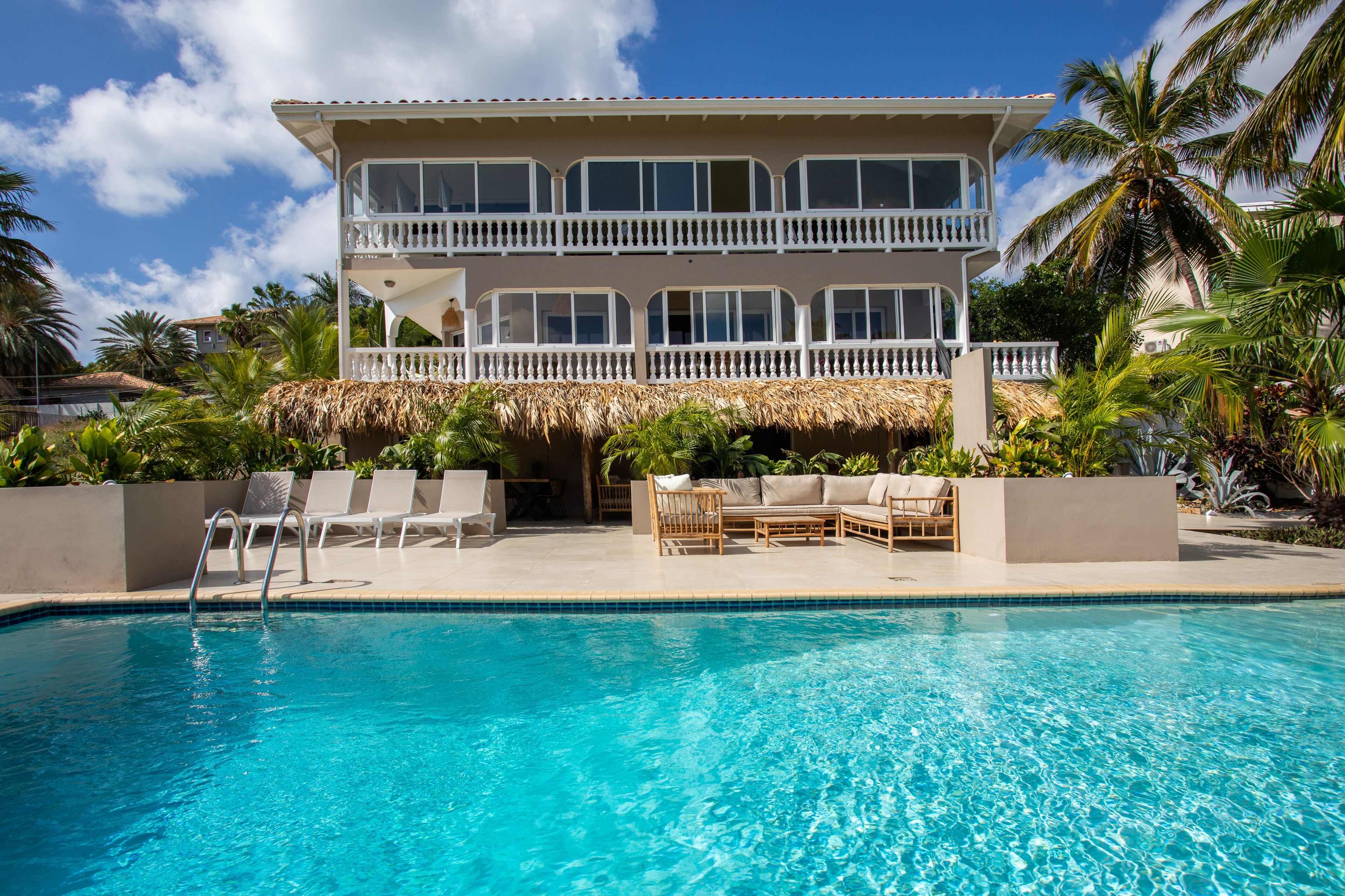 A two-story building with a pool in front.