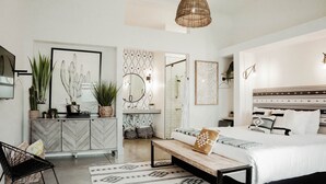 A modern bedroom with a bed, bedside table, and a hanging light fixture. - Reunion Hotel (Nashville)