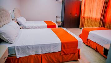 Habitación de hotel con dos camas, un armario, un televisor y una silla.