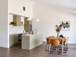 A modern kitchen with an island, wooden flooring, and pendant lighting. - Shawwood Winery Luxury Mudgee Farm Stay,  close to town and wineries (Bombira)