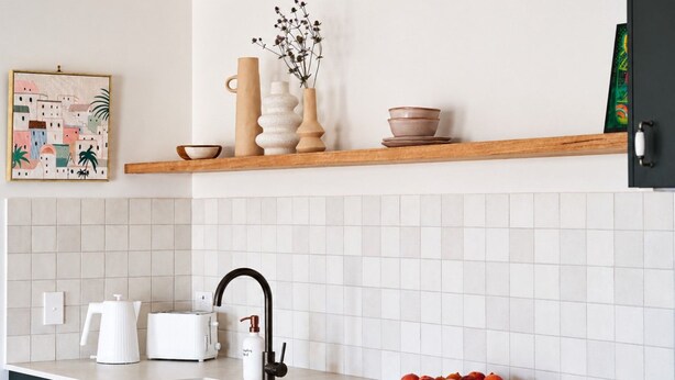 A modern kitchen with a white tiled backsplash, a wooden countertop, a black faucet, a white kettle, a toaster, a fruit bowl, and a vase with dried flowers on a shelf. - Shawwood Barrel Room Luxury Mudgee Farm Stay, close to town and wineries (Bombira)