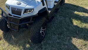 A white golf cart with a transparent windshield, black and white seats, and a raised front bumper. - 30A Private Pool Cottage with Pool and Golf Cart! (Santa Rosa Beach)