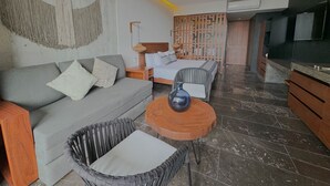 A modern living room with a sofa, a dining table, and a bed. - Luxury Studio-private individual pool (Tulum)