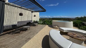 A rooftop patio with a wooden deck, outdoor seating, and a swimming pool. - Luxury Studio-private individual pool (Tulum)