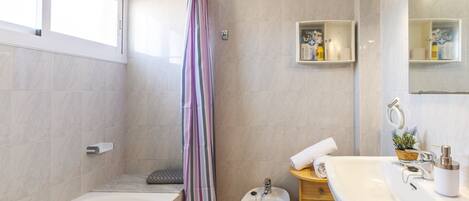 Shower, hair dryer, towels, toilet paper