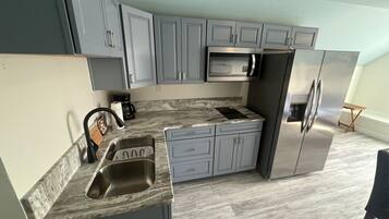 Fridge, microwave, stovetop, coffee/tea maker