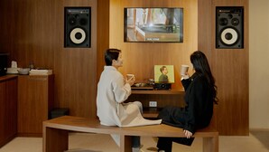 A room with a wooden wall, a television mounted above a wooden table, and two large speakers on either side. - Anook Hotel Suwon Ingye (Suwon)