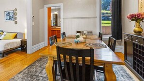 A dining area with a wooden table, black chairs, and a vase of flowers. - Mesaba Lake Superior View Condo, Heirloom Vacations (Duluth)
