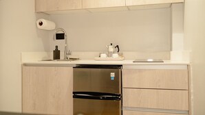 A compact kitchen with a built-in dishwasher, a sink with a faucet, and a coffee maker. - Downtown Punta Cana, Republica Dominicana.

 (Punta Cana)
