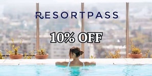 A person in a pool with a city view, potted plants, and text indicating a 10% off offer.