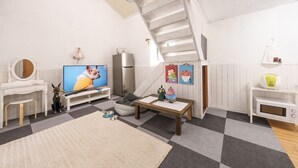 A living room with a TV, sofa, coffee table, and a staircase. - Gapyeong Jmong Choncance&camping Pension (Gapyeong)
