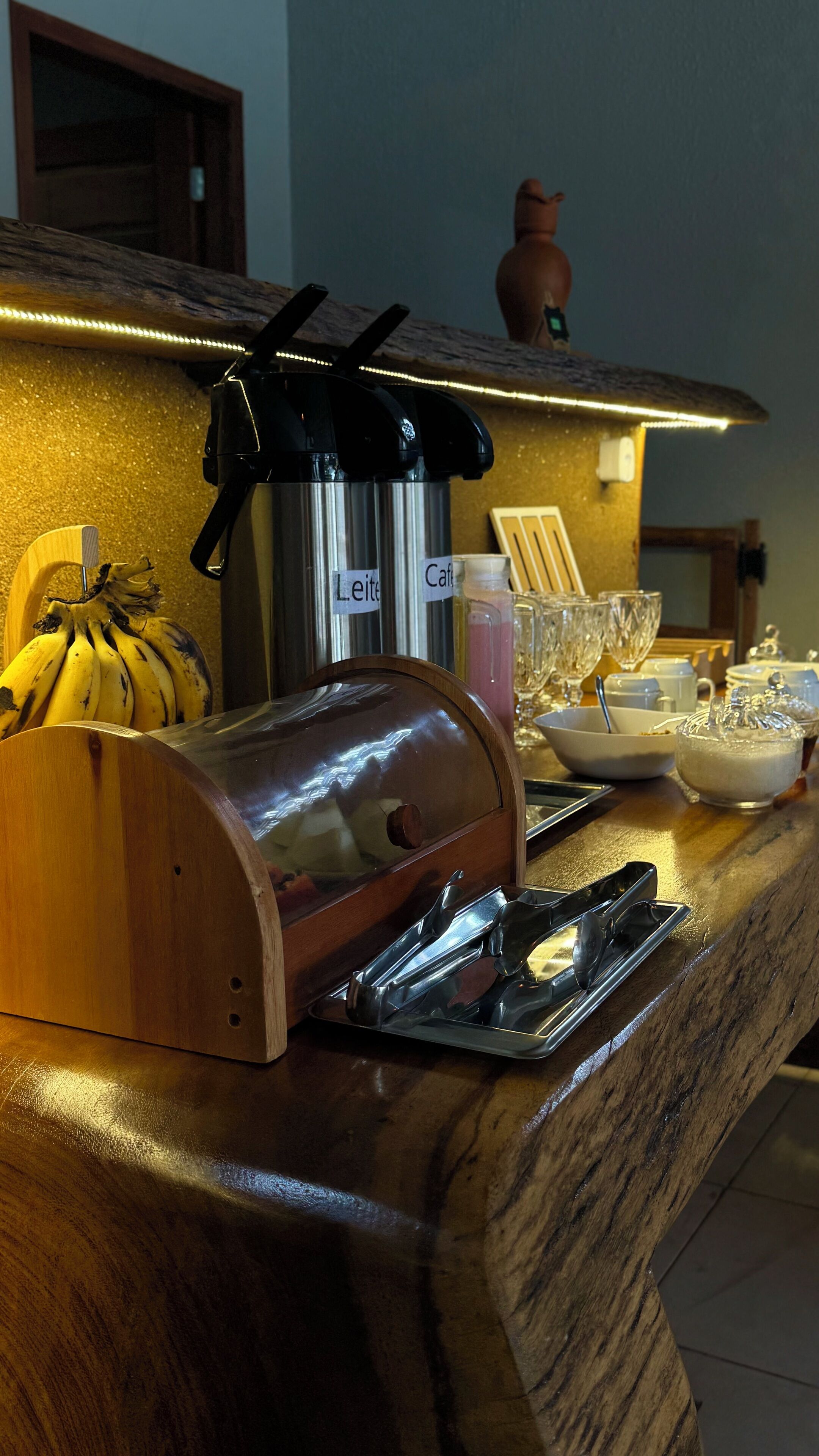 A kitchen counter with a coffee machine, a fruit bowl, and various kitchen utensils.