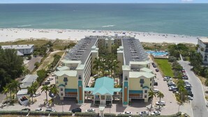 A hotel with a central courtyard, multiple floors, and a pool area.