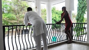 A room with a balcony, white walls, and a view of greenery outside. - UrbaN RootZ  (Abuja)