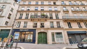 A multi-story building with a boutique hotel named "Ernest & Associates" on the ground floor.