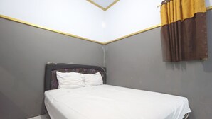 A single bed with white bedding in a room with grey walls and a yellow trim. - SPOT ON 93620 Anisa Homestay Syariah Near Pantai Gemah Tulungaggung (Tulungagung)