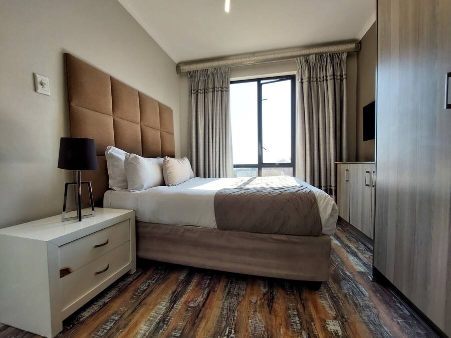 Premium bedding, Select Comfort beds, laptop workspace, blackout drapes