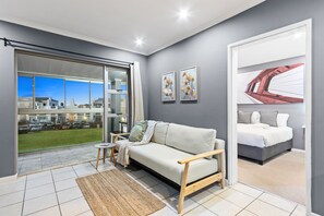 Apartment (1 Bedroom) | Living area | 42-inch LED TV with satellite channels - Big Bay Beach Club 73 (Cape Town)