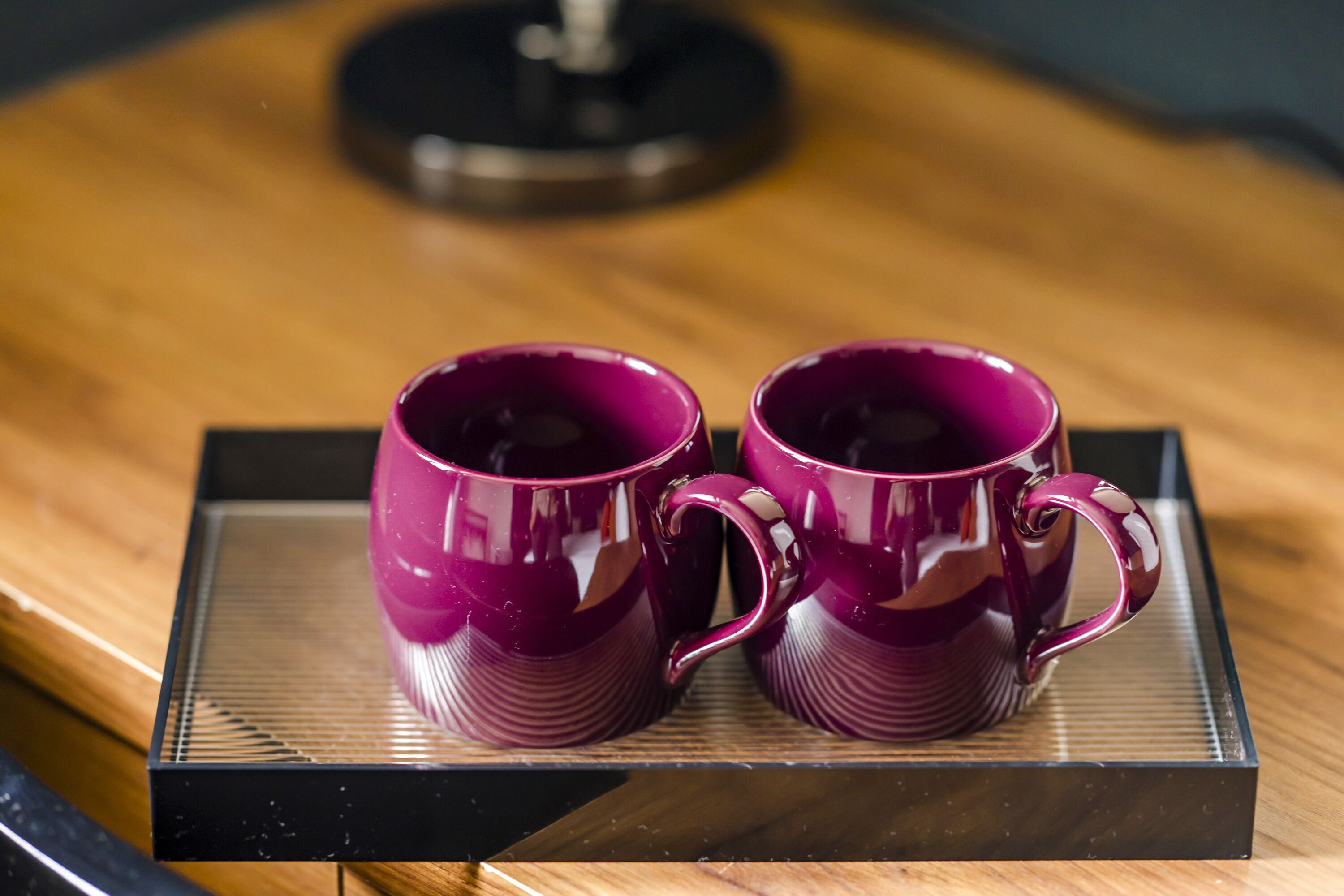 Two purple mugs on a tray.