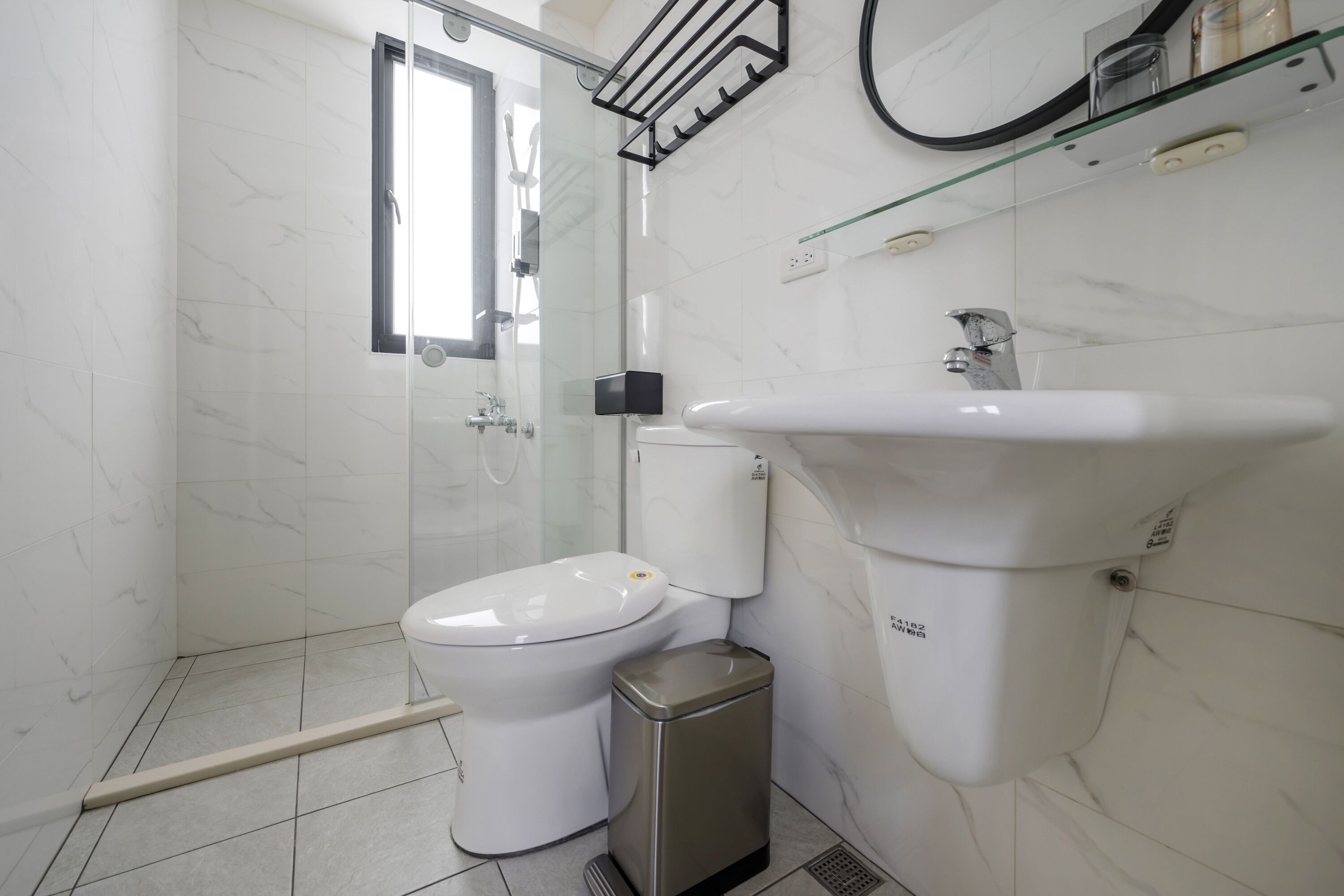 A modern bathroom with a toilet, bidet, and sink.