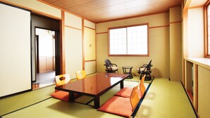 Ein traditioneller japanischer Raum mit Tatami-Boden, einem niedrigen Tisch und Schiebetüren.