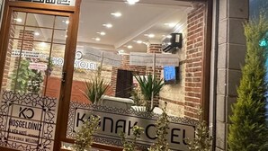 A hotel entrance with a sign reading "KONAK OTEK".