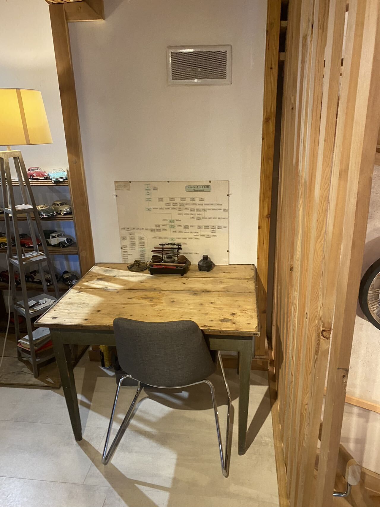 A wooden table with a whiteboard, a chair, and a ladder.