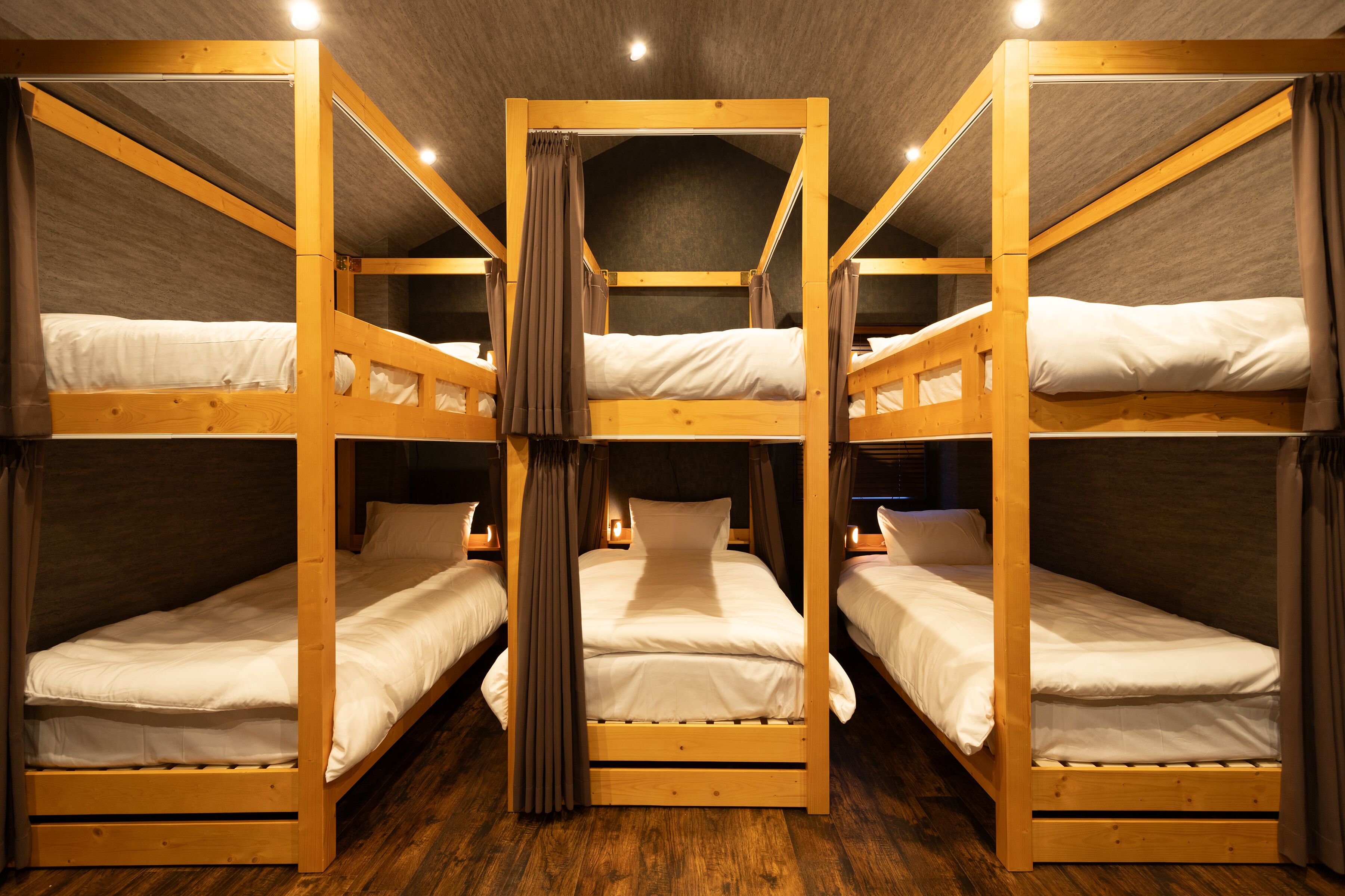 A room with four bunk beds arranged in a square layout.