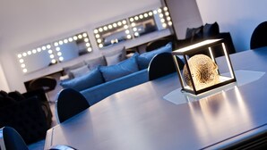 A modern dining area with a round table, a decorative centerpiece, and a seating arrangement with blue cushions.