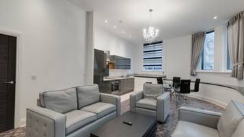 Comfort Apartment | Living area | 65-inch Smart TV with cable channels