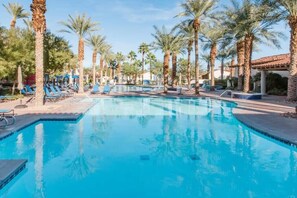 A swimming pool with palm trees and lounge chairs. - Rancho Sol B | Studio Legacy Villa (La Quinta)