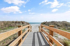 A wooden boardwalk leading to a beach with a clear sky. - Oceanfront at Carolina Reef w/ Pools, 2 Bds (North Myrtle Beach)