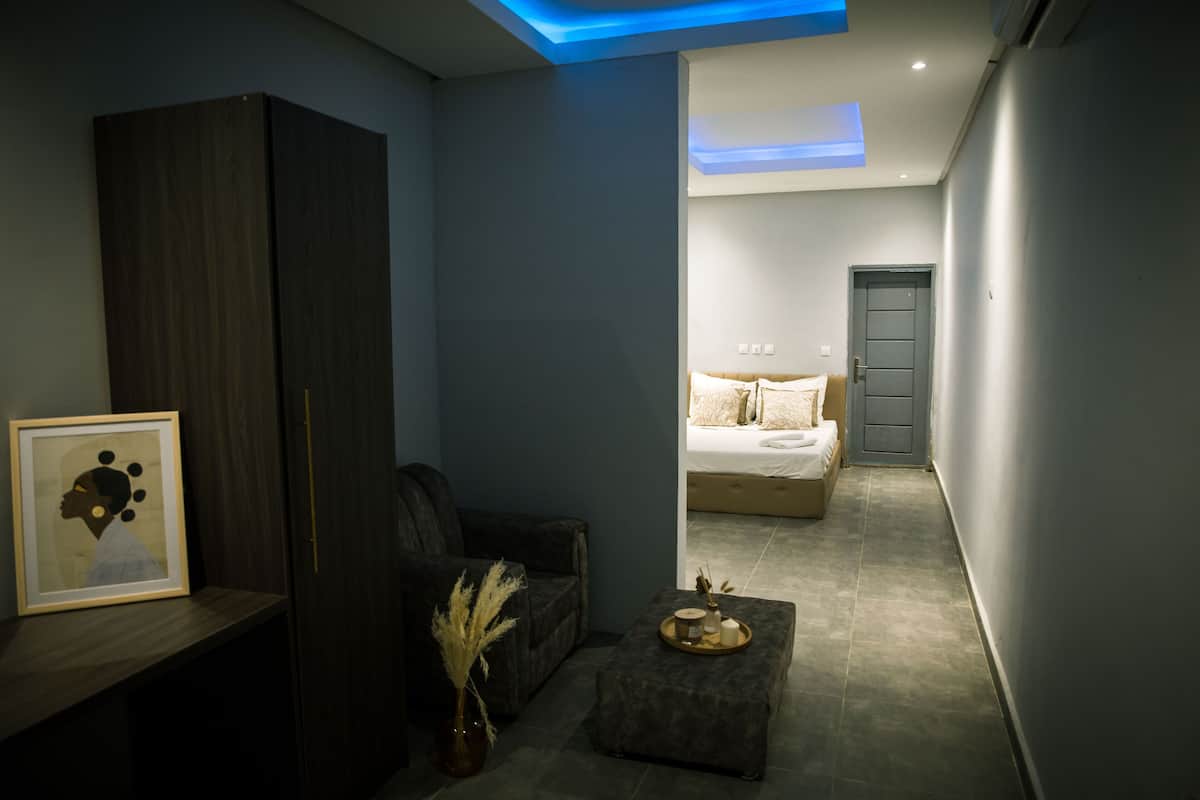 A modern bedroom with a bed, bedside table, and a nightstand.