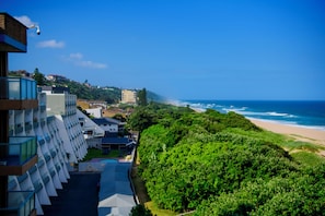 A coastal hotel with a view of the beach and ocean.