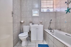 Apartment | Bathroom | Shower, deep soaking tub, towels, toilet paper