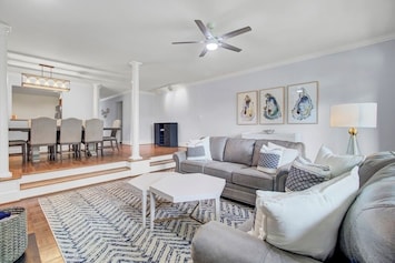 - Kick back on plush sofas in this light filled living space made for connection - Bold rug, modern art, and comfy textures bring coastal charm and comfort together - Whether it’s movies, game night, or quiet reading, this is your go to hangout