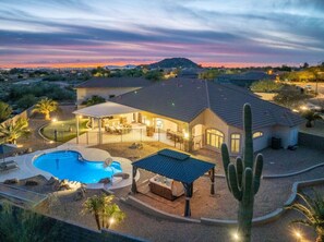 A residential property with a swimming pool, patio, and a covered outdoor seating area. - Mountainside Desert Retreat (Mesa)