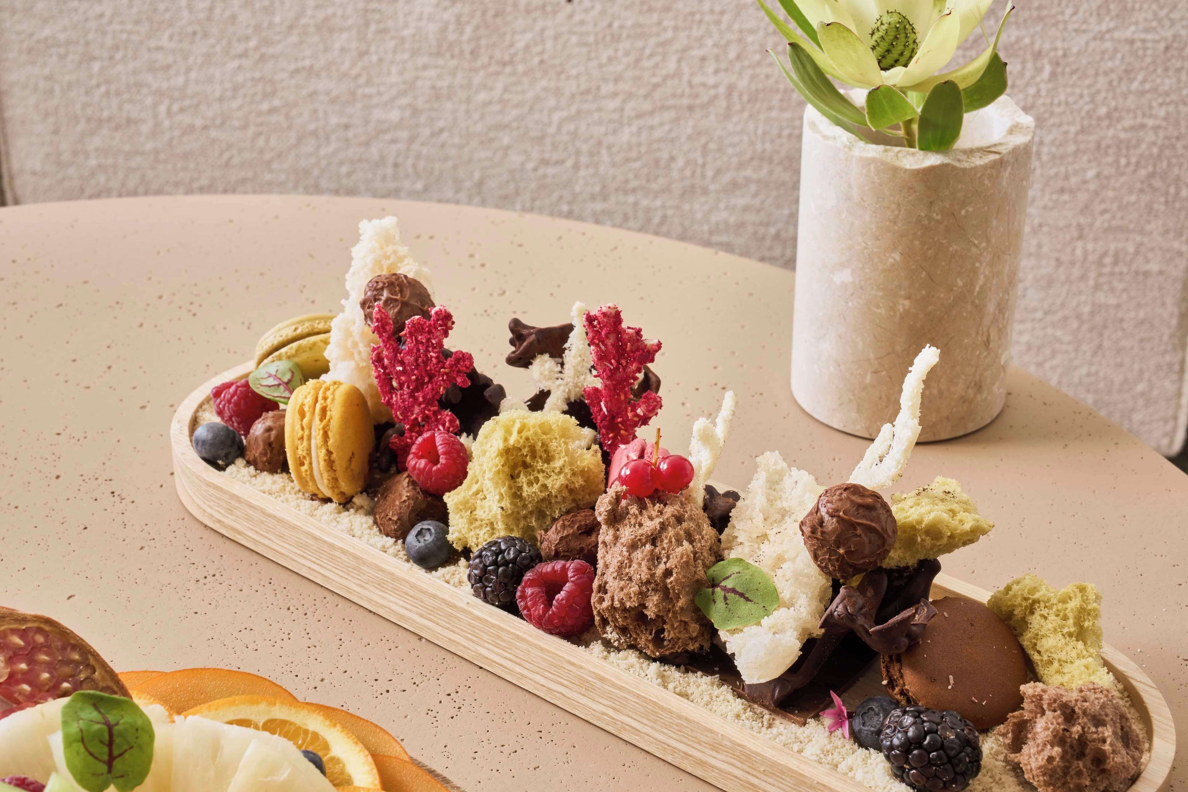 A dessert platter with various sweets and fruits on a table.