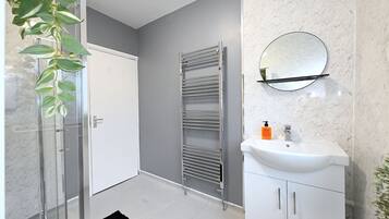 Shower, hair dryer, towels, toilet paper