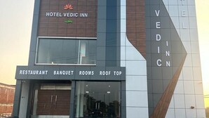 A hotel with a modern design, featuring a restaurant, banquet, rooms, and a roof top area. - Hotel Vedic Inn (Kiraoli)