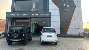A modern hotel with a prominent 'Hotel Vedic Inn' sign, a restaurant, banquet rooms, and a roof top area. - Hotel Vedic Inn (Kiraoli)