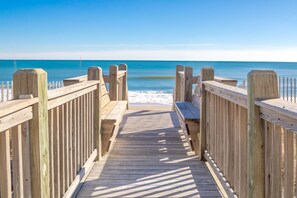 A wooden boardwalk leading to a beach with a clear view of the ocean. - Island Life - Amazing Oceanfront 9 BR Home with Pool, Theatre Room & More! (North Topsail Beach)